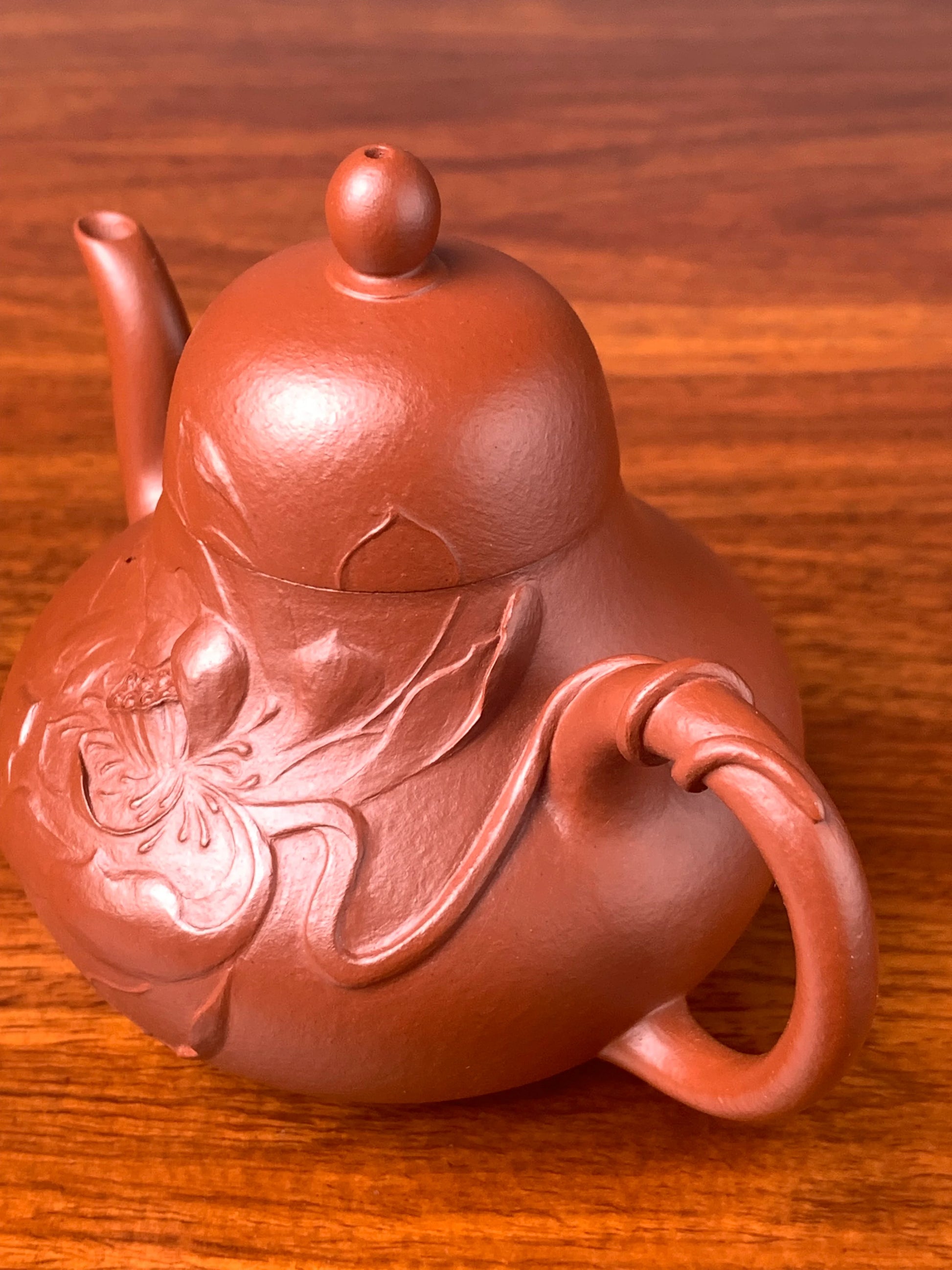 Close-up right-side view of the lotus sculpture on the teapot body