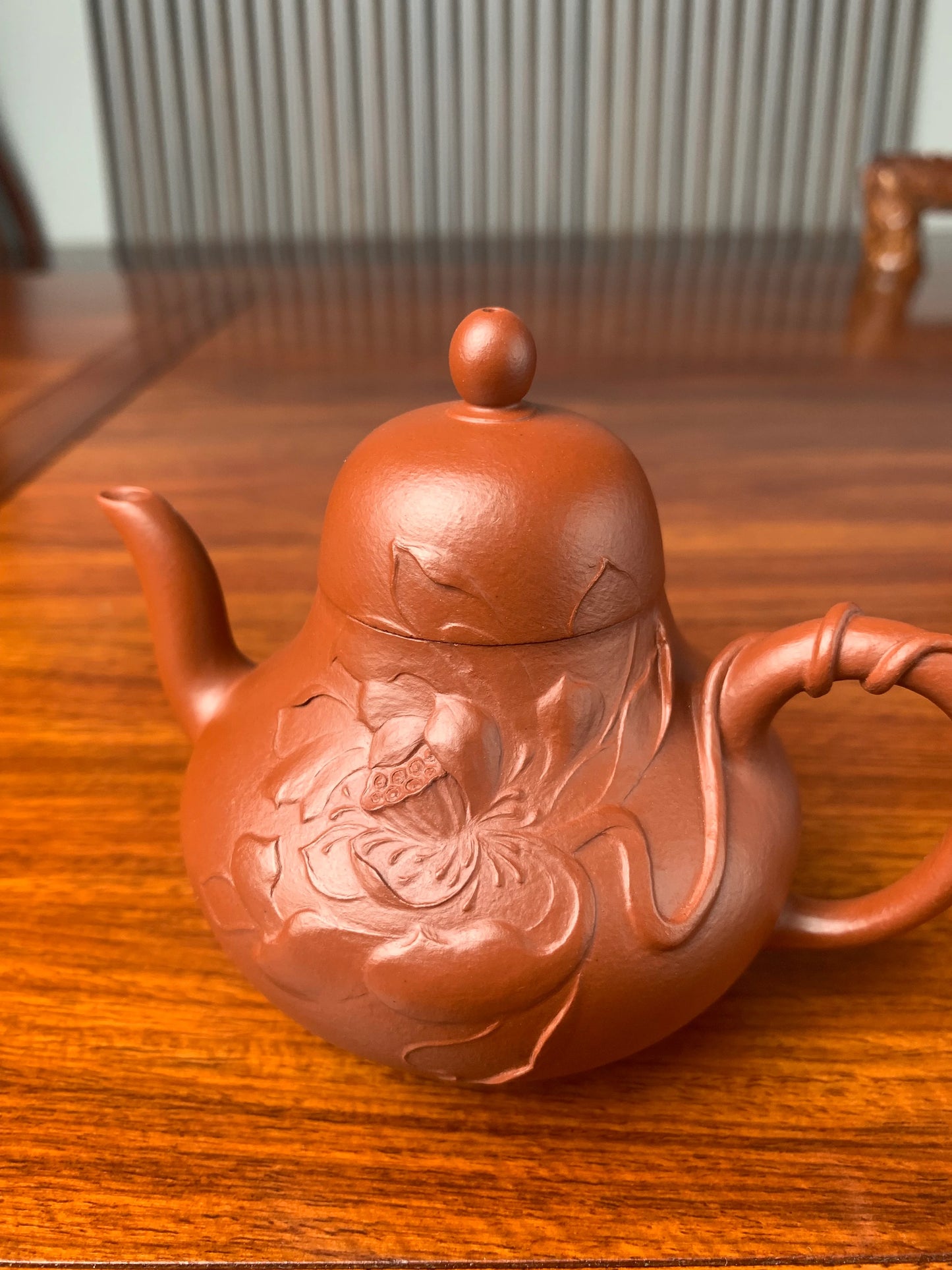 Close-up right view of the lotus sculpture on the teapot body