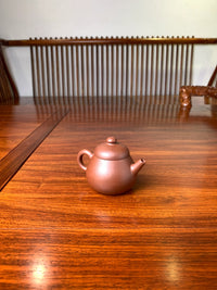 the left view of the zisha teapot named wen dan
