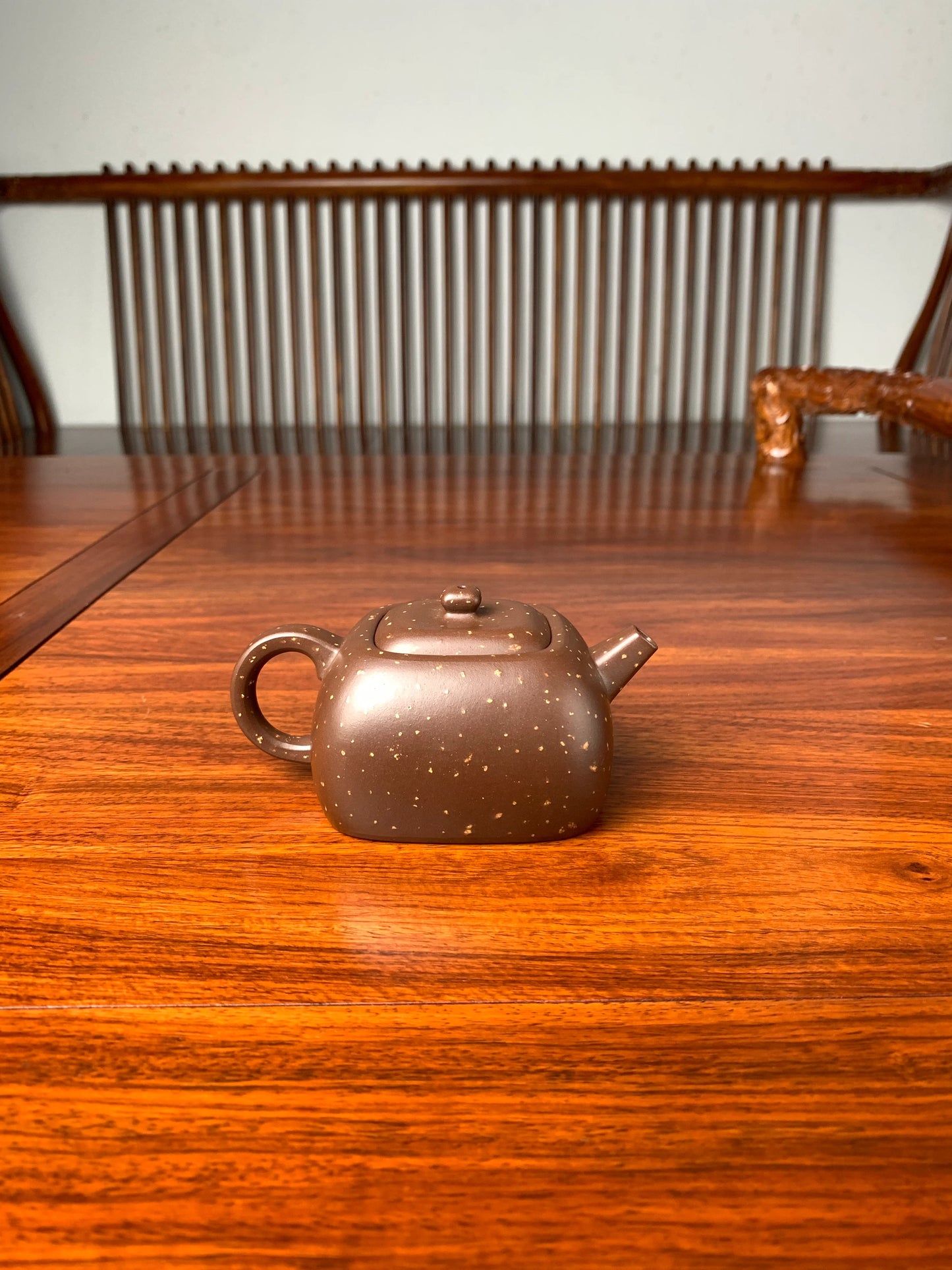 the back view of the zisha teapot on the table