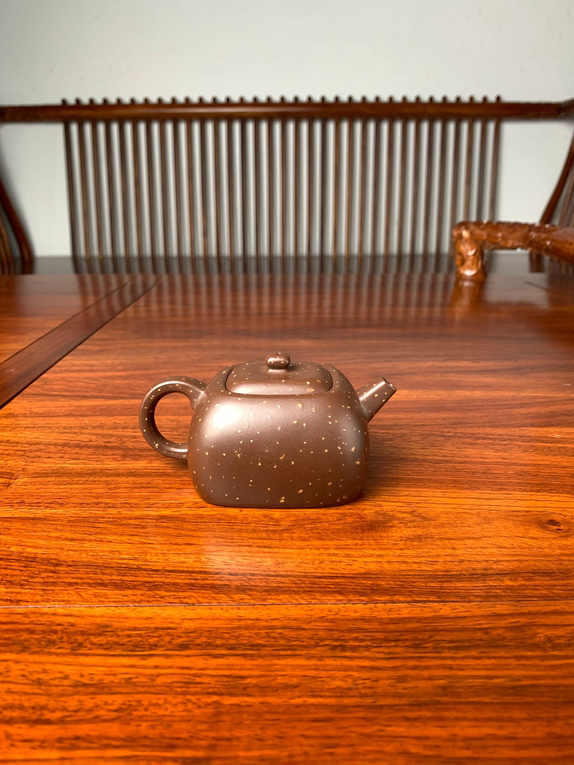the back view of the zisha teapot on the table