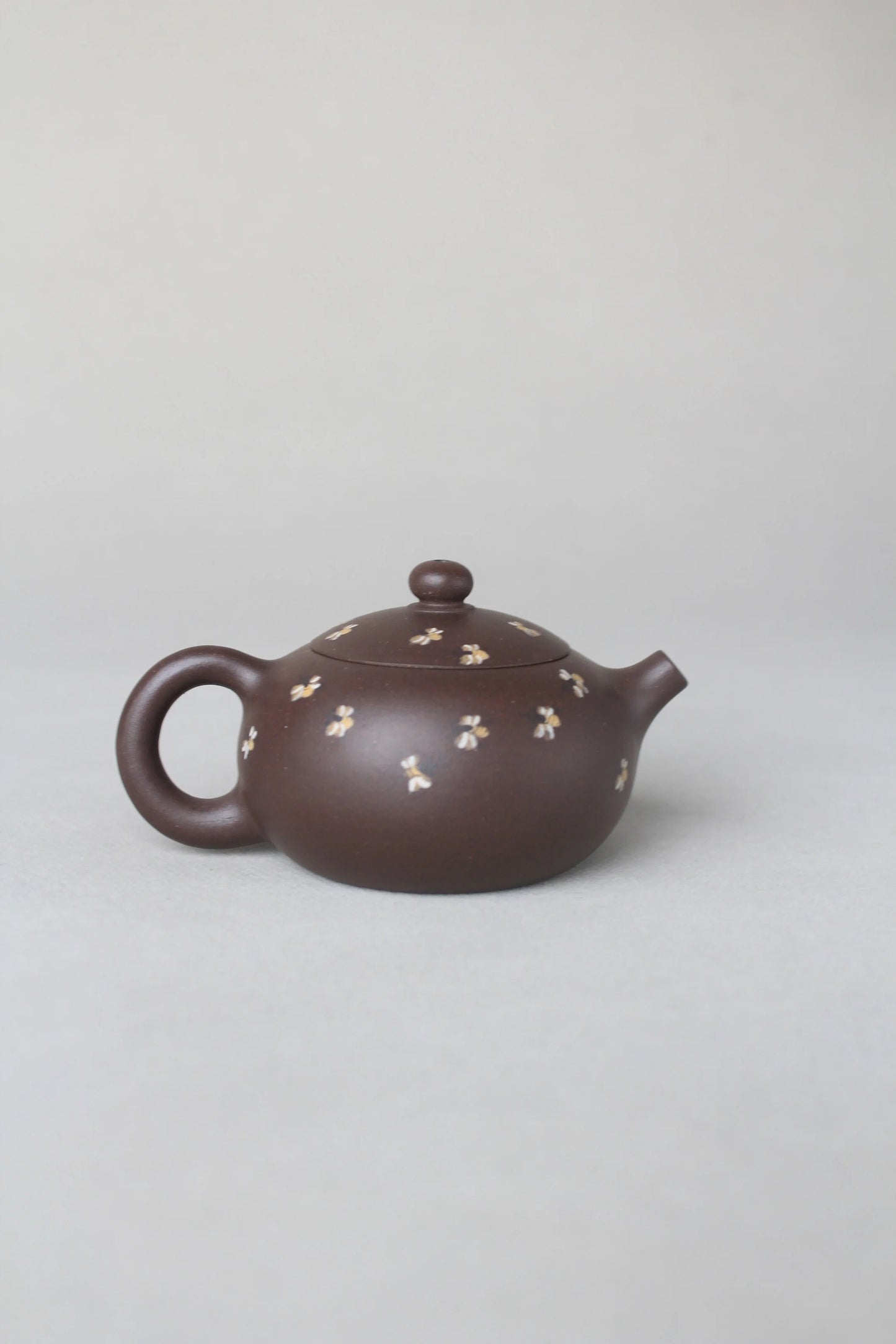 back view of small zisha teapot named xishi
