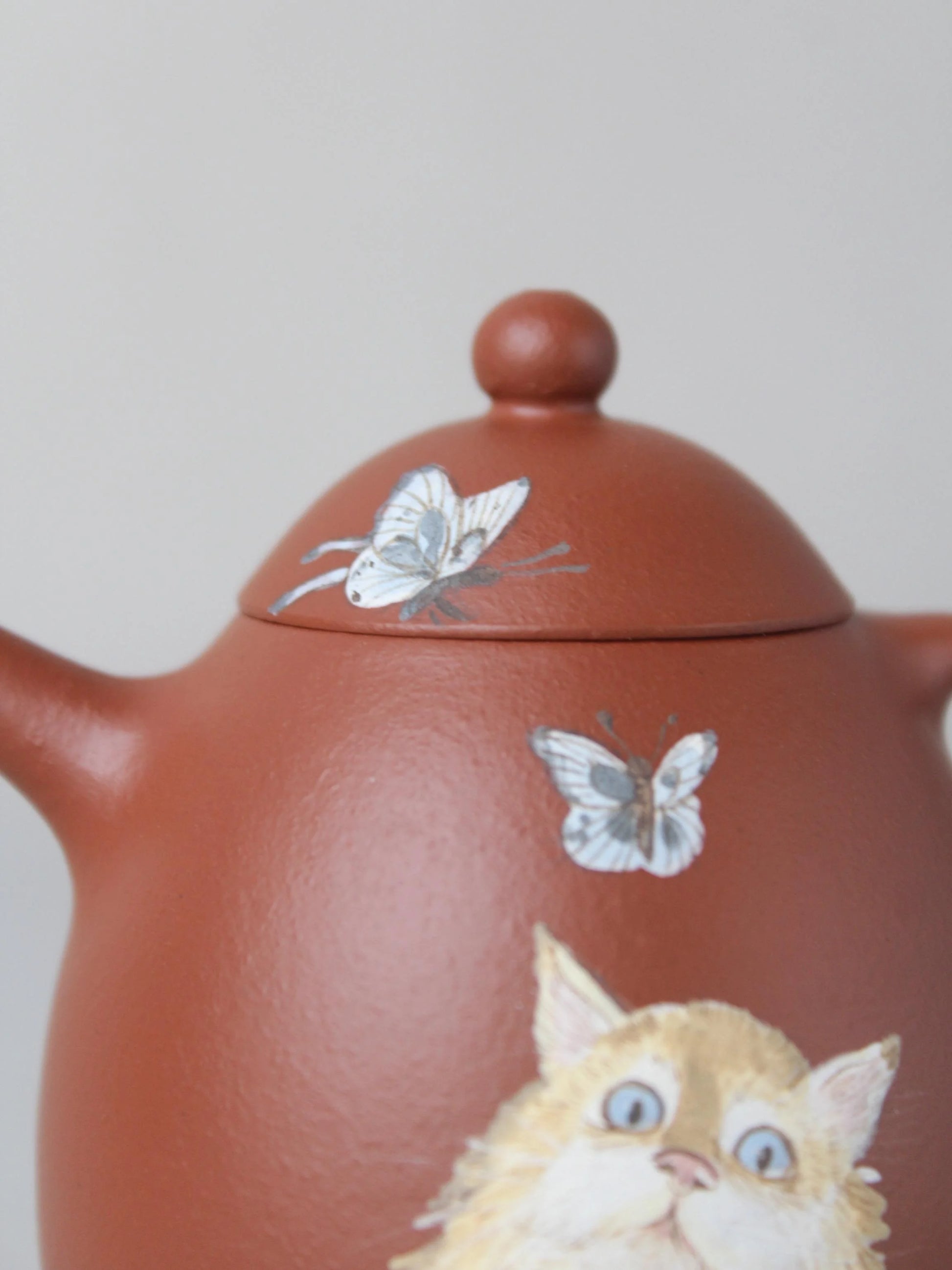 detail of the dragon egg zisha teapot with cat painting